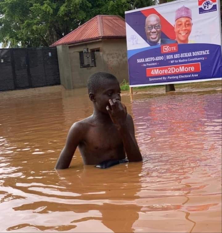 young boy swims in a flood
