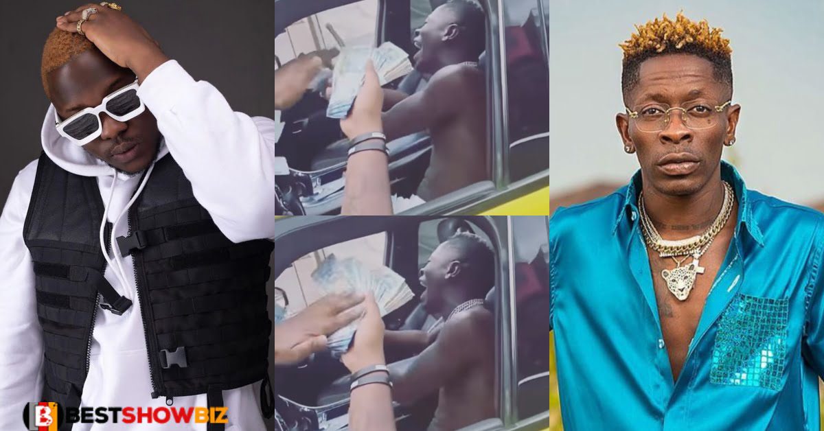 Medikal proves to be the richest musician as he rains bundles of cash on Shatta Wale in new video