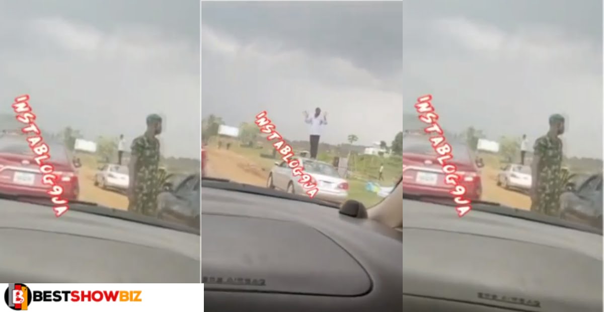 Watch how a Soldier Instruct a Driver to stand on his cars and wave other cars after Violating traffic laws