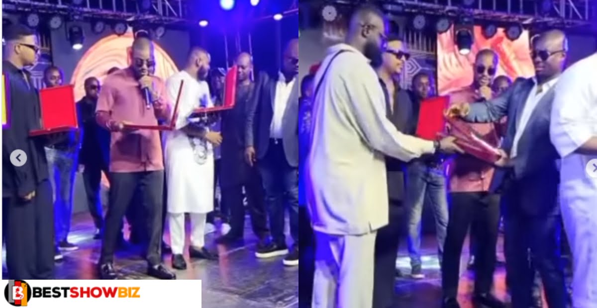 Obi Cubana, a billionaire, presents N1 million and a certificate of appreciation to his loyal employees.