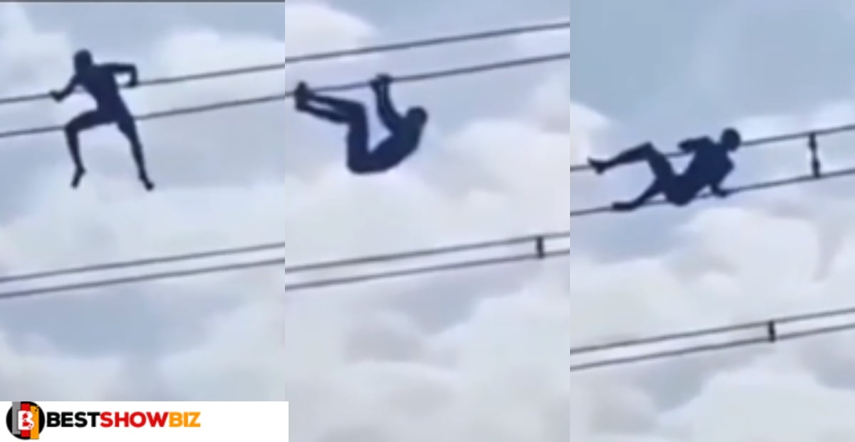 Thief climbs high tension wire to avoid been beaten by youth (video)