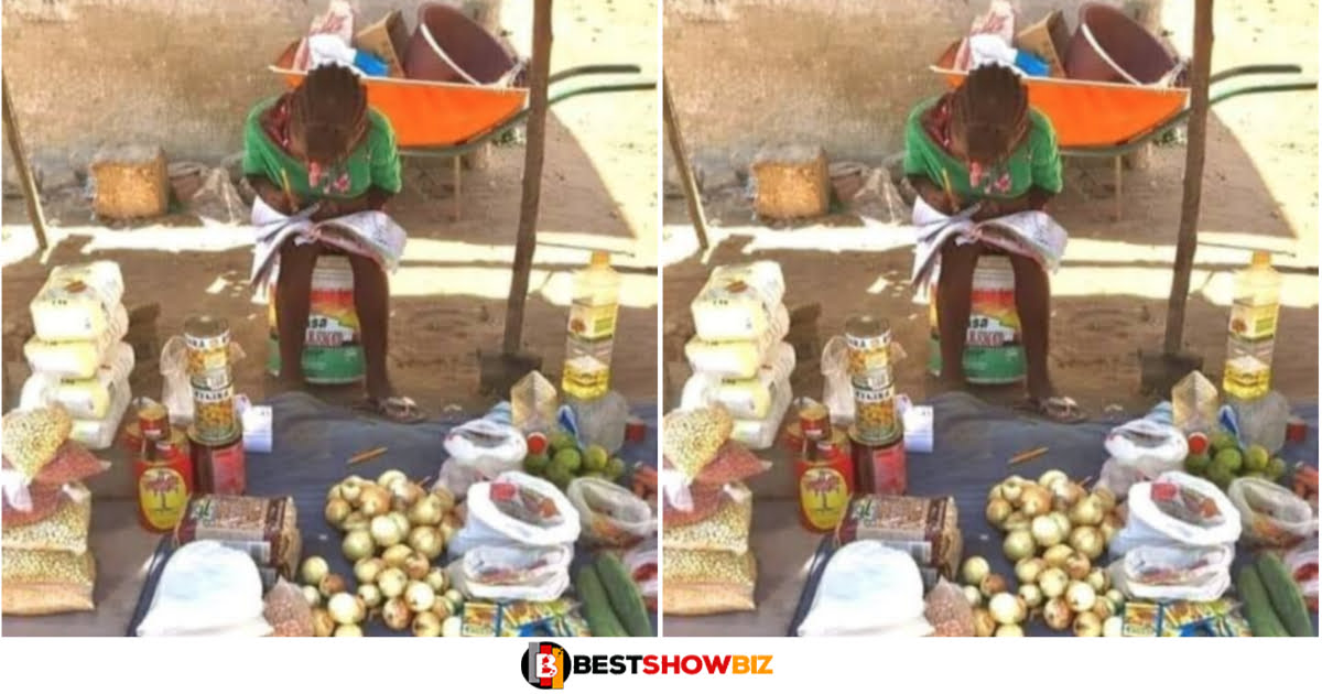 Young female student spotted studying while helping her mother sell at the market (Photo)