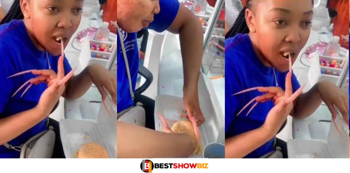 Reactions as lady with extra-long nails struggles to eat in public (Video)