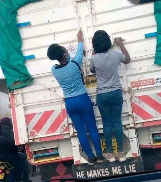 Two slay queens spotted hanging at the back of a truck as they couldn't afford trotro