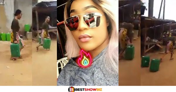 (Video) Popular Slay Queen hides from the camera after being caught carrying gallons of water