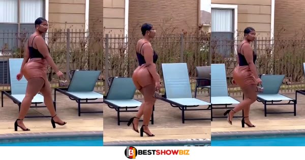(Video) Beautiful lady shows off her fine body in a tight dress at poolside