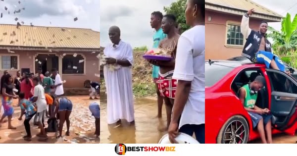 Young man who threw money in the air while people picked, is spotted in new video carrying out a ‘ritual’ with a juju man in a river