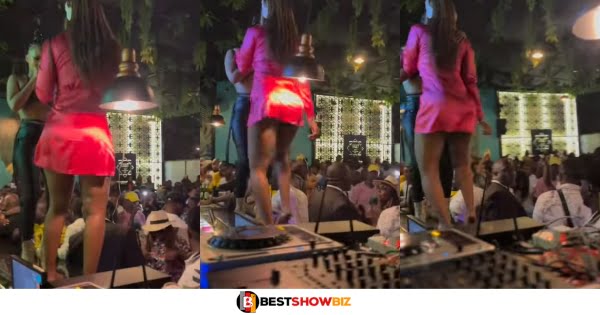 Lady dances panty-l3ss at a public event wearing a short red skirt.