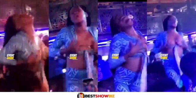 Lady spotted vigorously massaging her own b()0bs at a club after getting drunk (watch video)