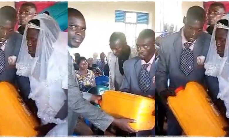 Massive reactions as Man gifts bride and groom an empty jerrycan on their wedding day - Watch Video